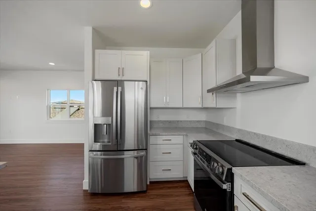 a kitchen with stainless steel appliances granite countertop a sink stove and cabinets