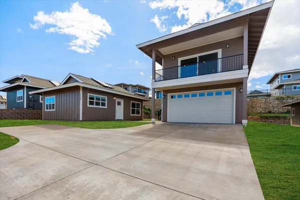 a front view of a house with a yard and garage
