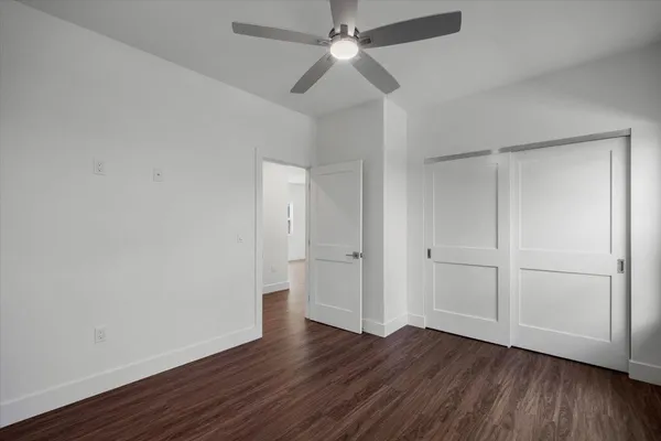 a view of wooden floor and windows in a room