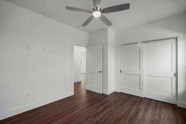 a view of wooden floor and windows in a room