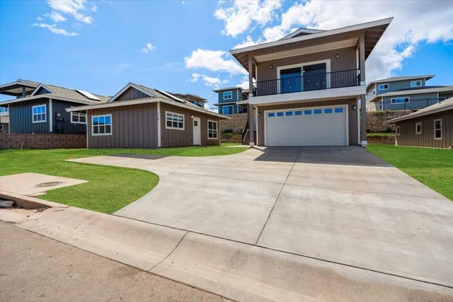 a view of a house with a yard and garage