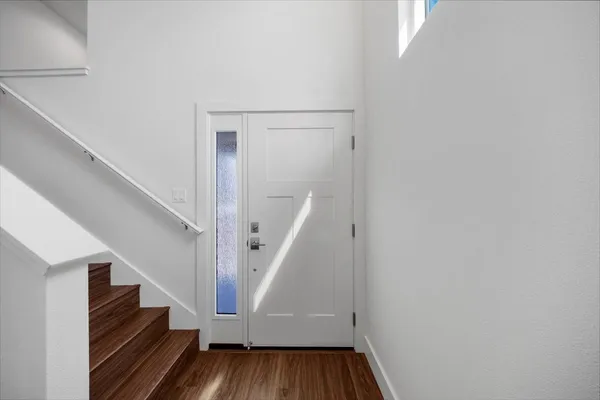 a view of entryway and hall with wooden floor