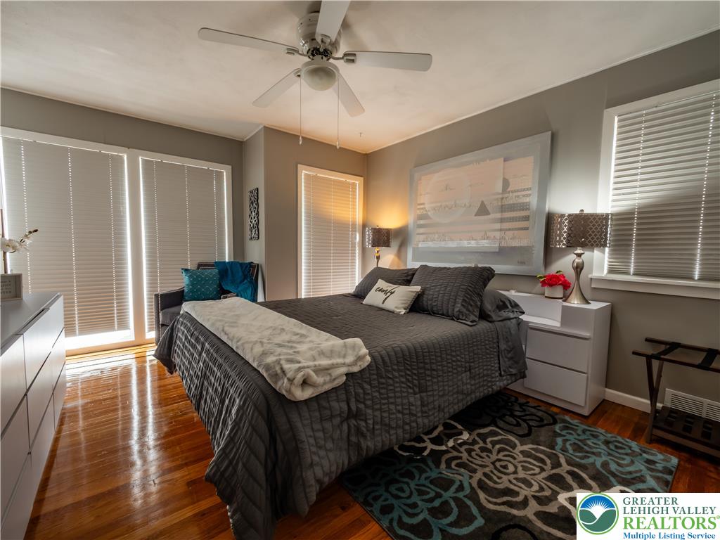 2087 Hopewell Road Bethlehem, PA 18017 - Photo 28 of 38 Hardwood flooring and multiple windows provide natural light in this inviting bedroom space.