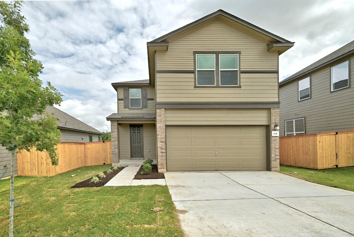 128 Robert Hightower Cove Jarrell, TX 76537 - Photo 1 of 1 a front view of a house with a yard