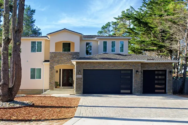 a front view of a house with a yard and garage