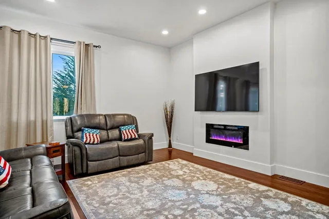 a living room with furniture flat screen tv and a fireplace