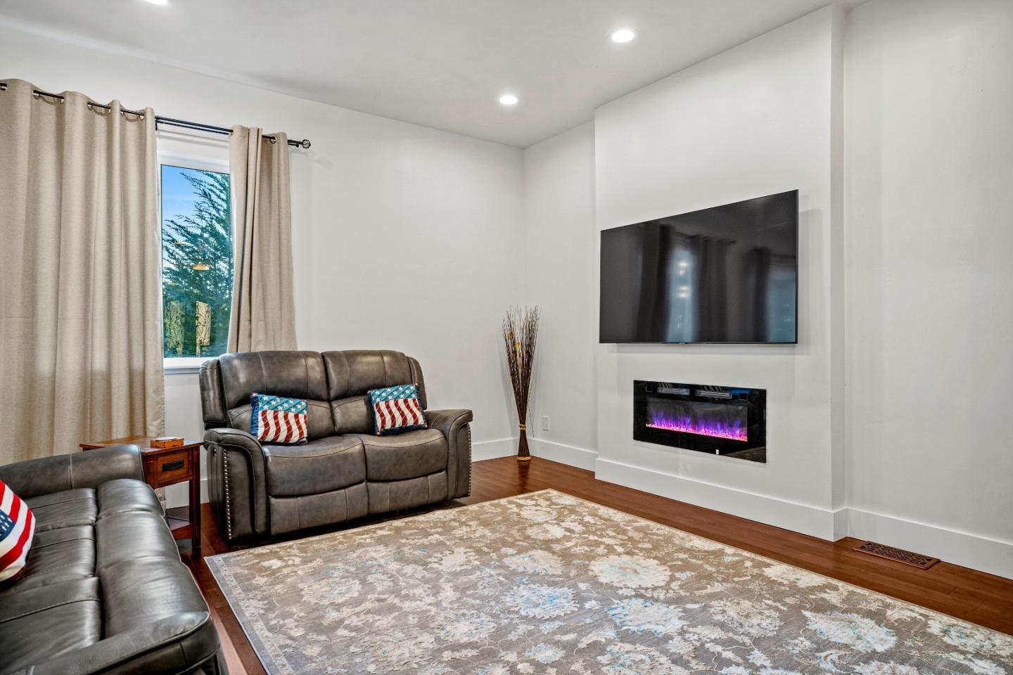 4044 Sunset Lane Pebble Beach, CA 93953 - Photo 14 of 39 a living room with furniture flat screen tv and a fireplace