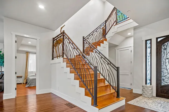 a view of entryway with wooden floor and stairs