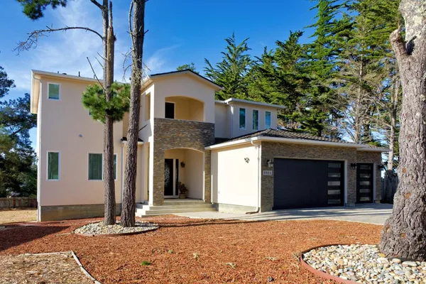 a front view of a house with a yard and garage
