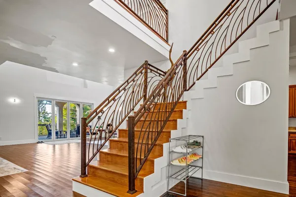 a view of entryway and hall with wooden floor