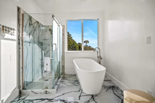 a bathroom with a granite countertop toilet sink and mirror