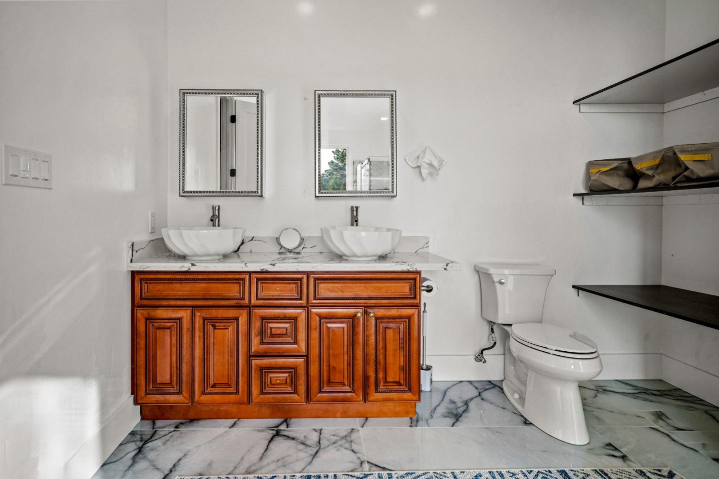 4044 Sunset Lane Pebble Beach, CA 93953 - Photo 34 of 39 a bathroom with a granite countertop toilet sink and mirror
