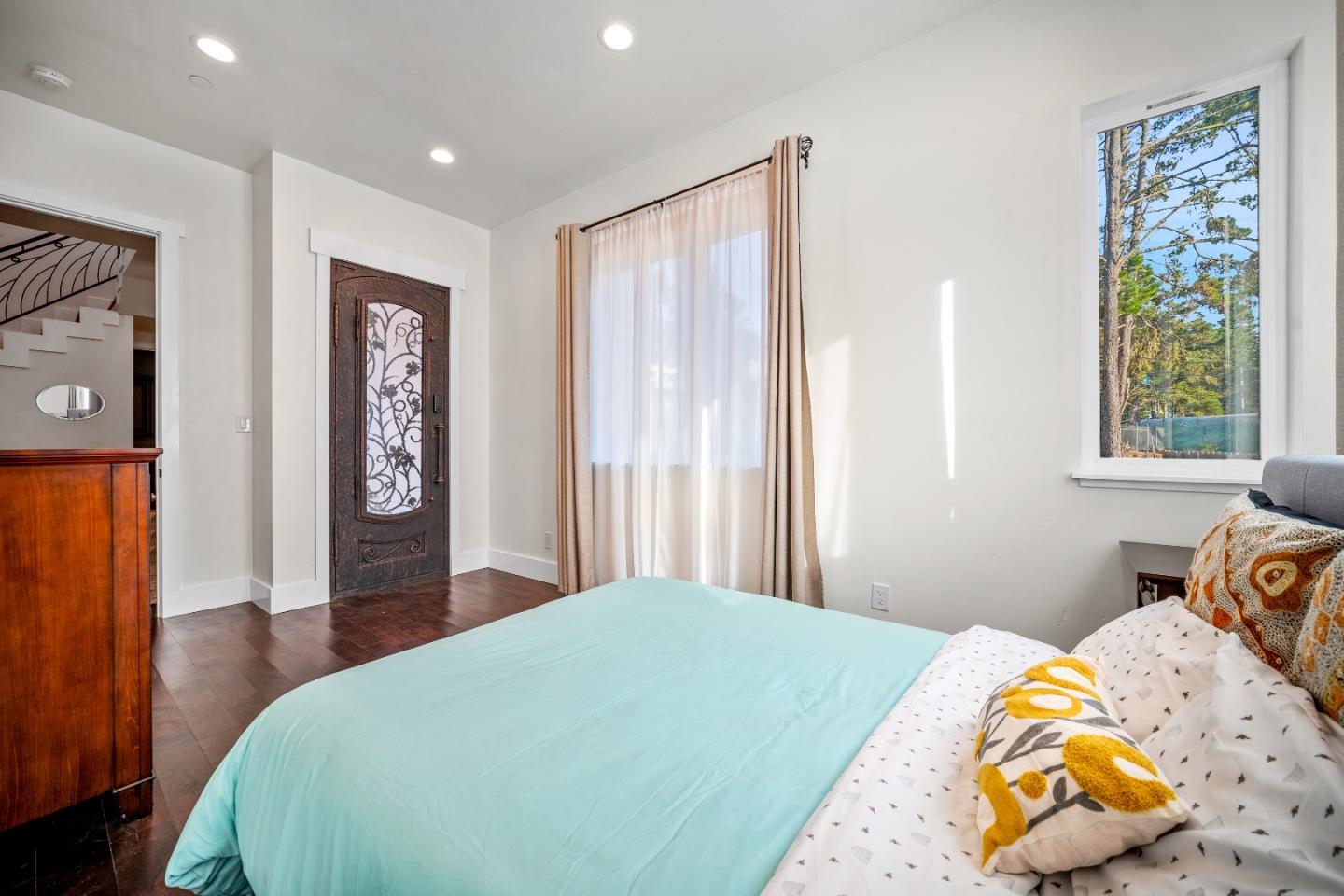 4044 Sunset Lane Pebble Beach, CA 93953 - Photo 35 of 39 a bedroom with a bed and painting on the wall