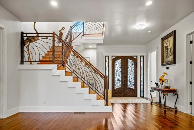 a view of entryway and hall with wooden floor