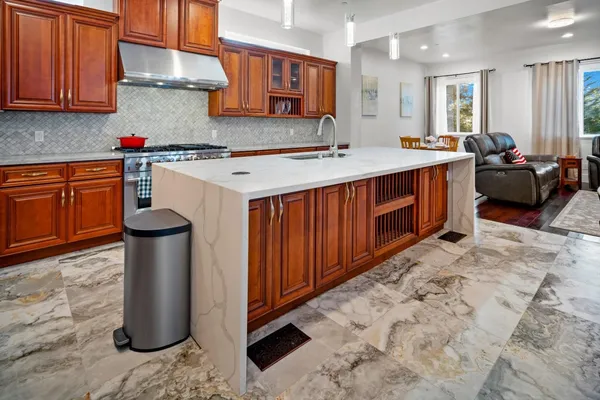 a kitchen with a sink refrigerator and cabinets