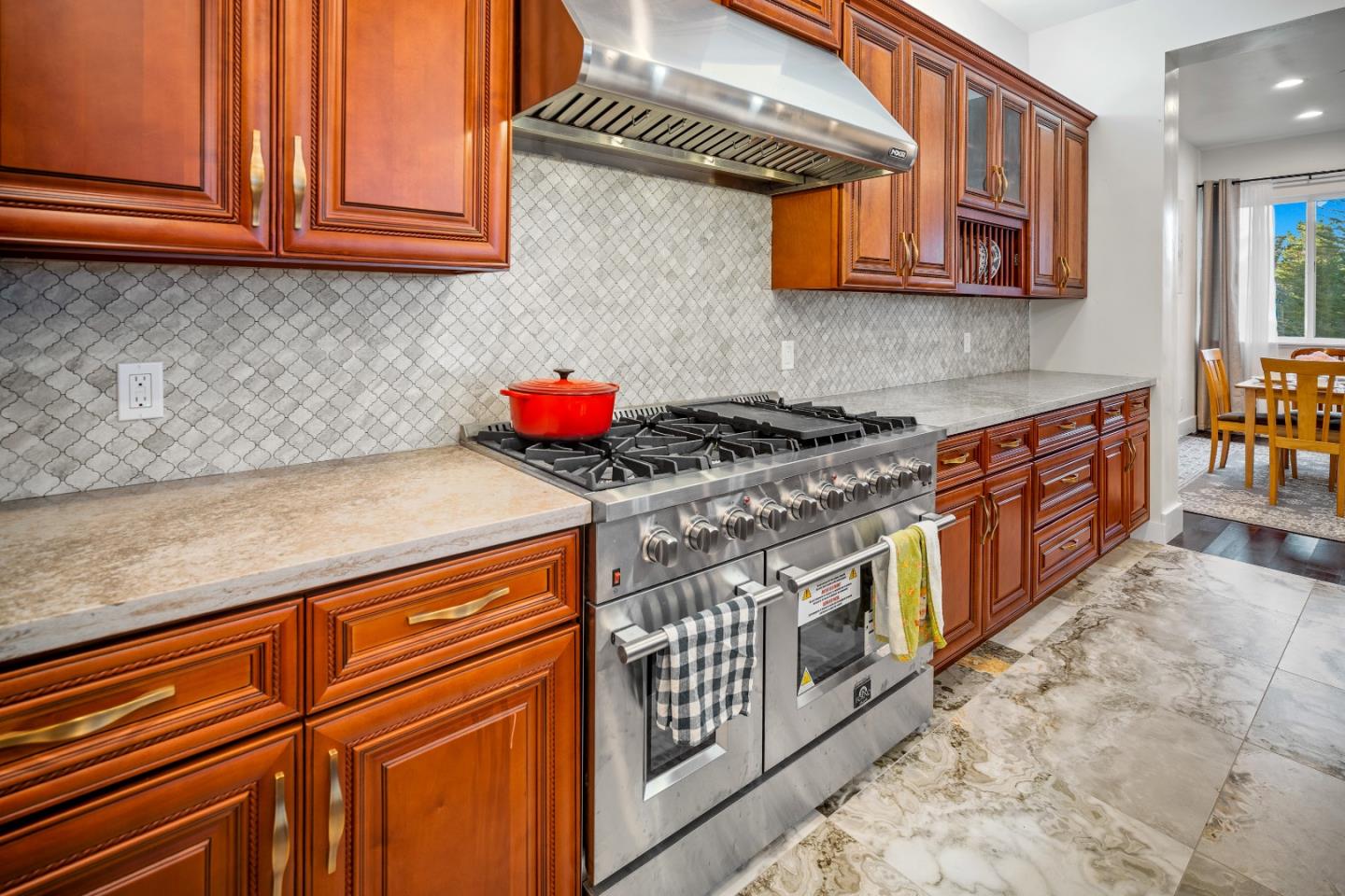 4044 Sunset Lane Pebble Beach, CA 93953 - Photo 7 of 39 a kitchen with stainless steel appliances granite countertop a stove and cabinets