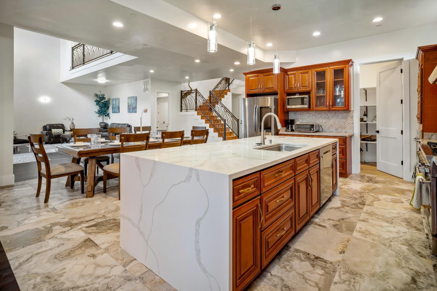 4044 Sunset Lane Pebble Beach, CA 93953 - Photo 8 of 39 a kitchen with stainless steel appliances granite countertop a sink and a refrigerator