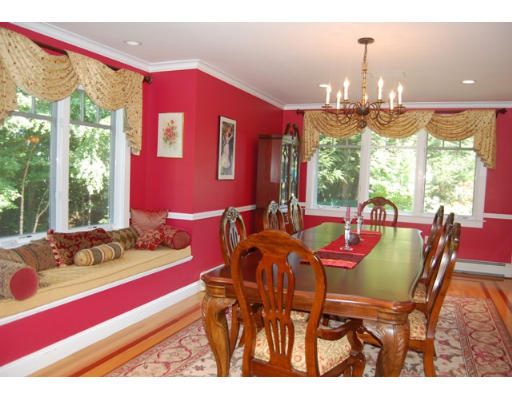 6 Brookwood Road Lexington, MA 02420 - Photo 9 of 27 a view of a dining room with furniture a chandelier and large windows