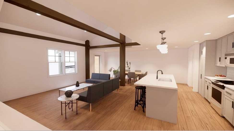 a living room with furniture a large window and wooden floor