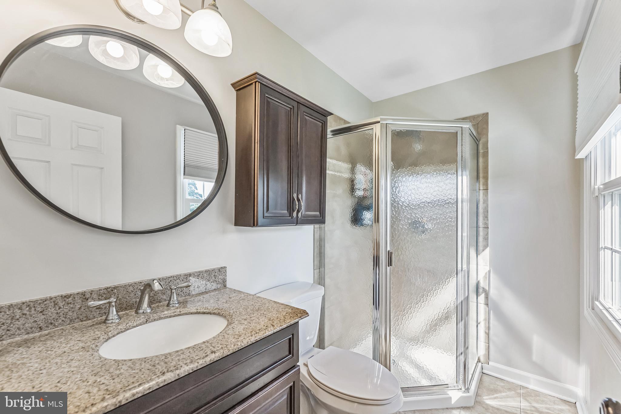 23 New Oak Road Mickleton, NJ 08056 - Photo 16 of 30 a bathroom with a granite countertop sink mirror vanity and toilet