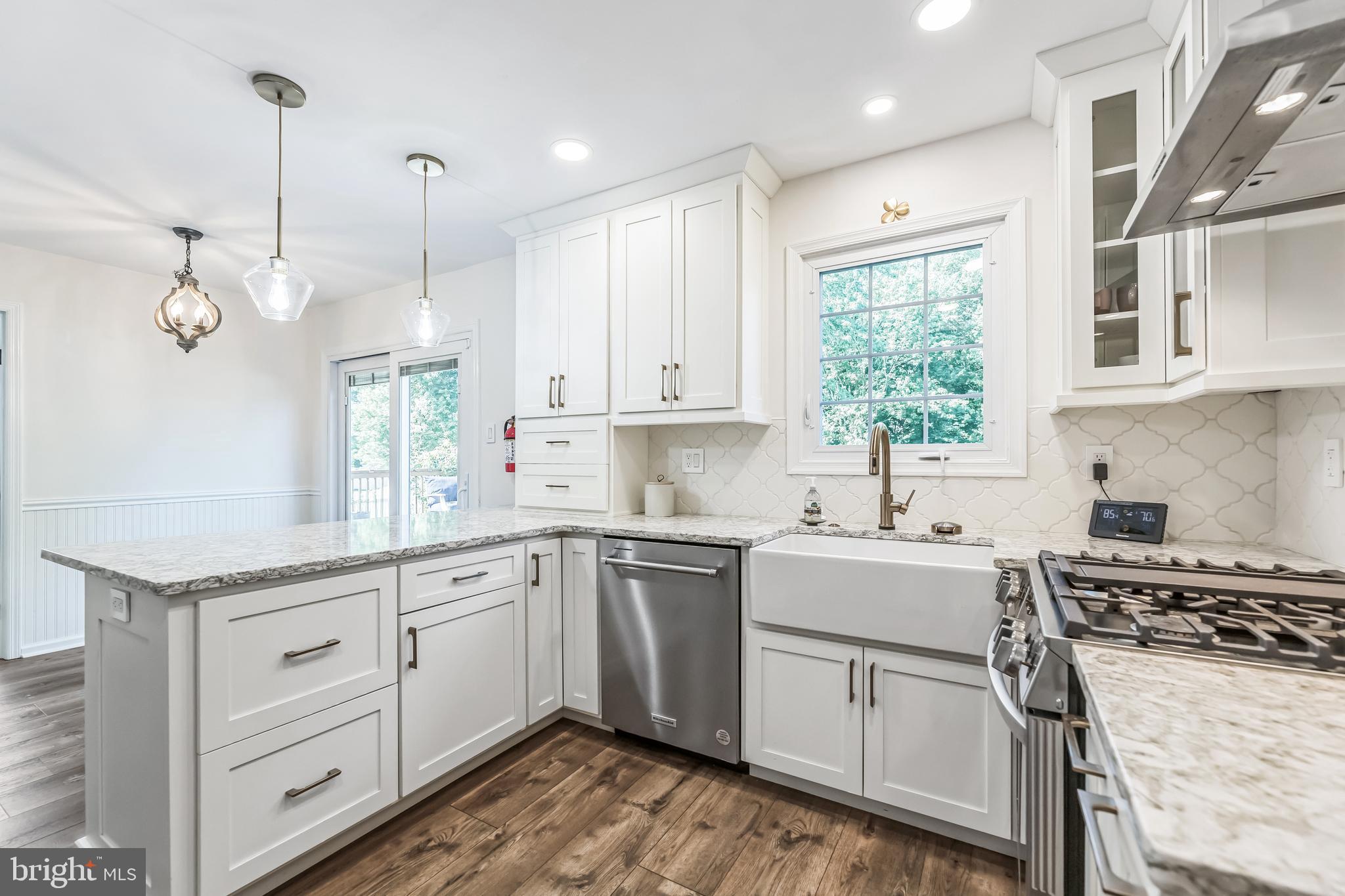 23 New Oak Road Mickleton, NJ 08056 - Photo 2 of 30 a kitchen with a stove a sink a center island and windows