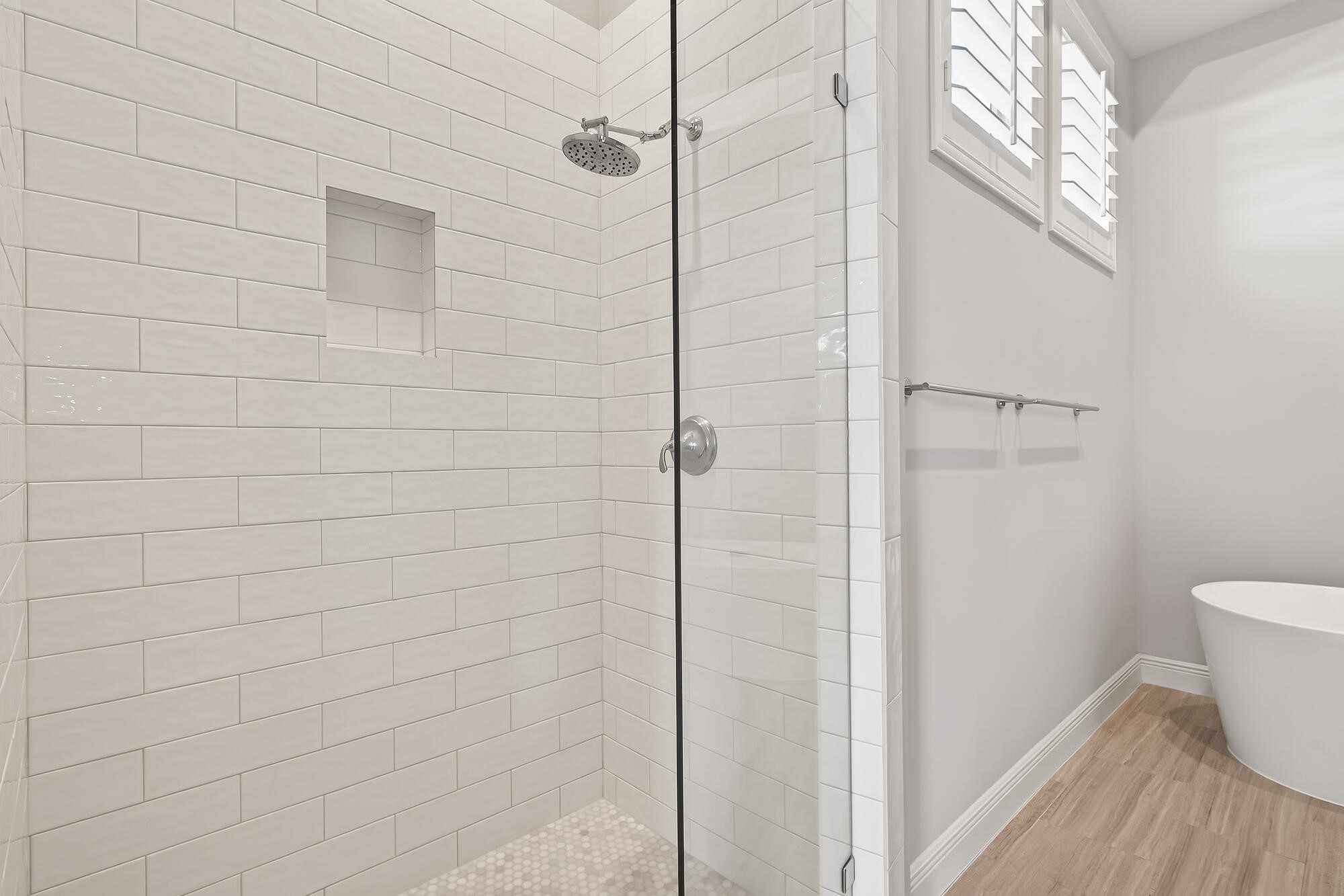 122 Gateway Park Place Spring, TX 77380 - Photo 30 of 44 Sleek remodeled bath with frameless glass shower, subway tile surround, and plantation-shuttered window.