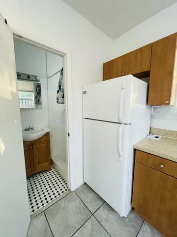 an empty room with a ceiling fan and window