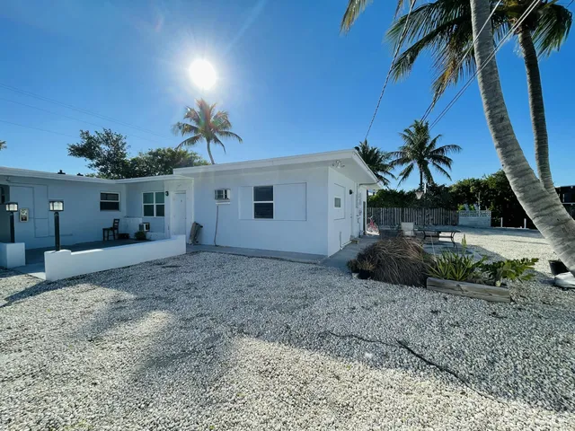a view of a backyard with a chair and table