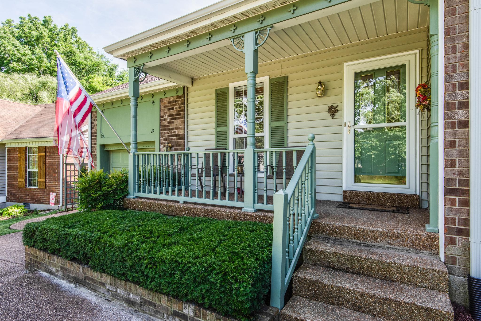 1444 Hunters Branch Road Antioch, TN 37013 - Photo 2 of 27 An inviting porch to enjoy the outside! Attached one car garage with extra storage built above the vehicle area with steps built in leading up to it! We all need easy access to extra storage space!
