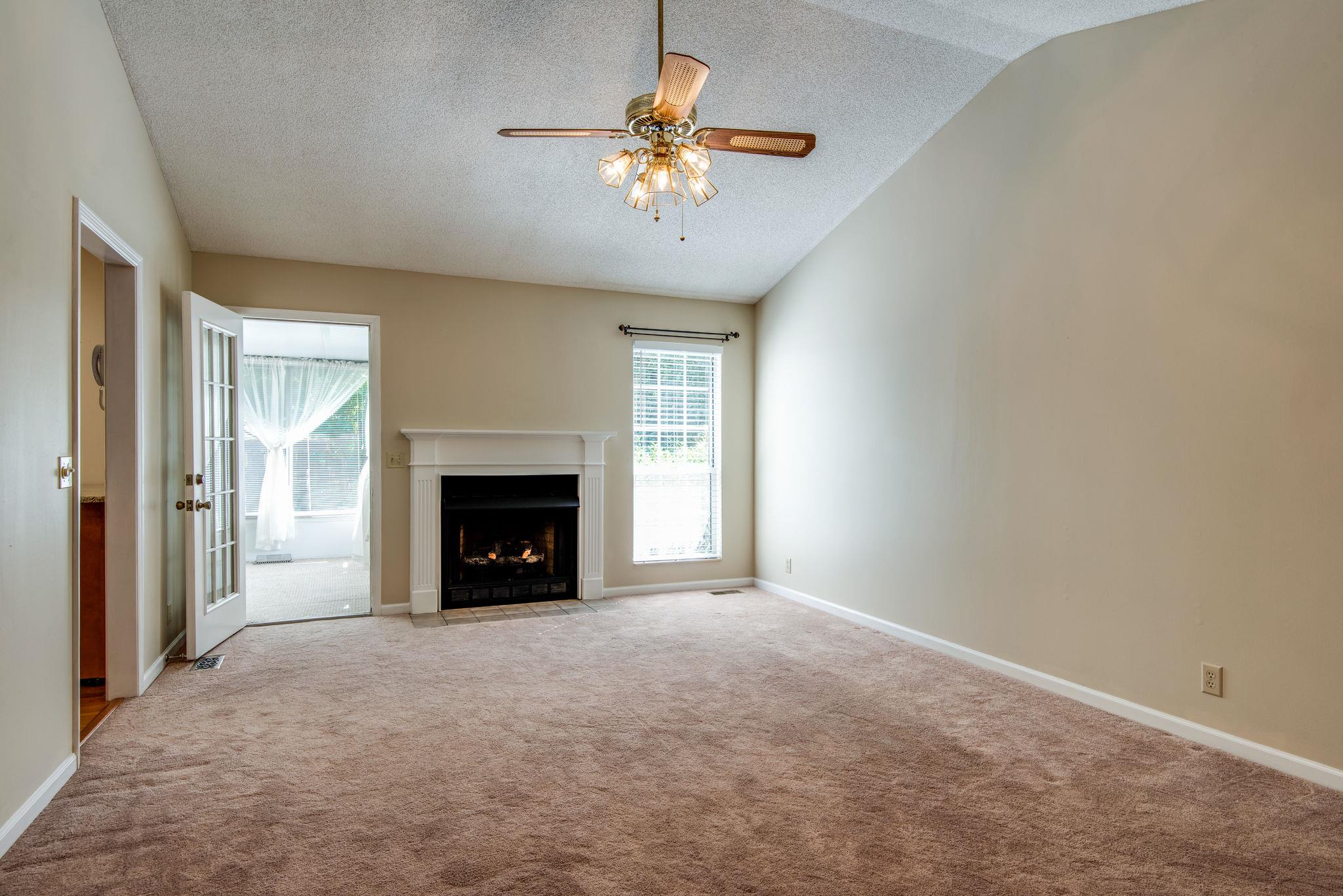 1444 Hunters Branch Road Antioch, TN 37013 - Photo 6 of 27 Large family room with fireplace leads into the sun room.