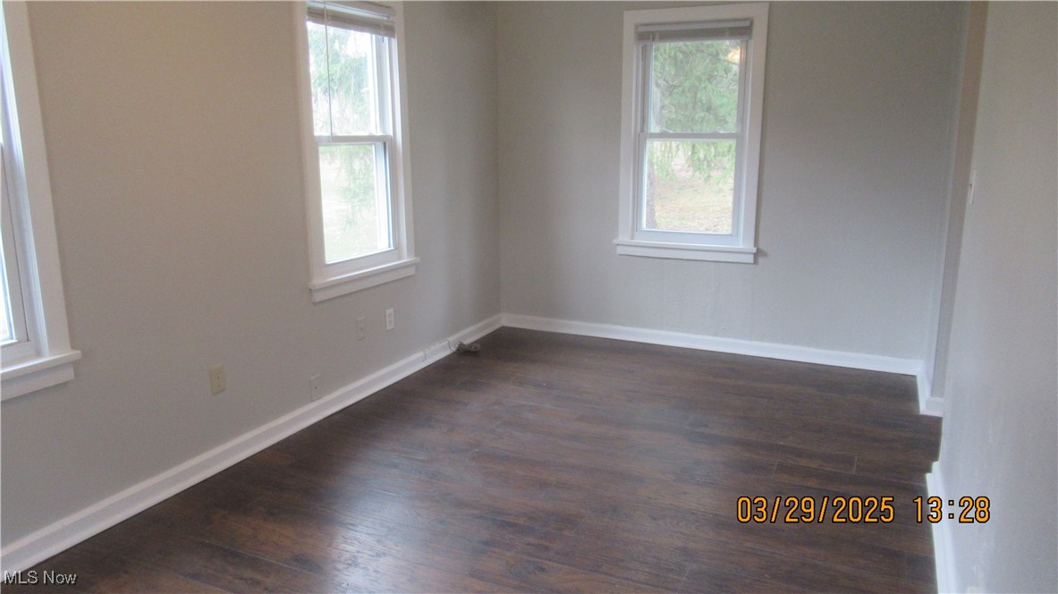36505 Pettibone Road Solon, OH 44139 - Photo 16 of 24 Empty room featuring a wealth of natural light, baseboards, and dark wood-style floors