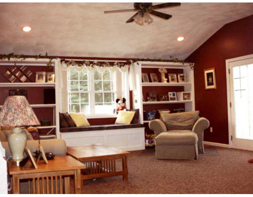 25 Springwell Road Billerica, MA 01821 - Photo 5 of 7 a living room with furniture a flat screen tv and a window