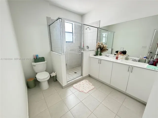 a bathroom with a sink mirror toilet and shower