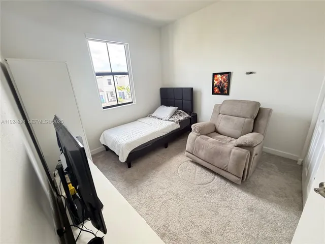 a bedroom with furniture and a window