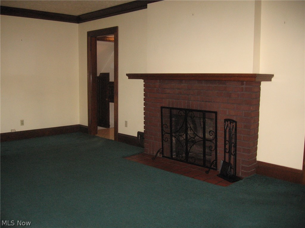 1399 Brookline Road Cleveland, OH 44121 - Photo 3 of 12 Beautiful brick fireplace in the large living room.