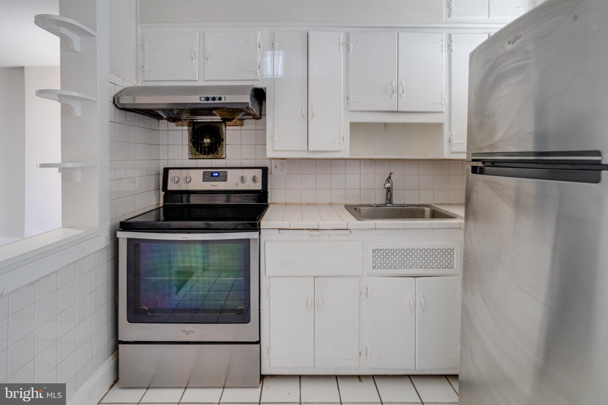 5878 Belair Road Baltimore, MD 21206 - Photo 15 of 41 a kitchen with a stove and a microwave