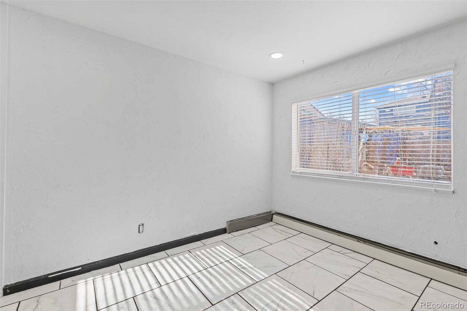 1630 Chester Street Aurora, CO 80010 - Photo 13 of 31 a view of an empty room with a window