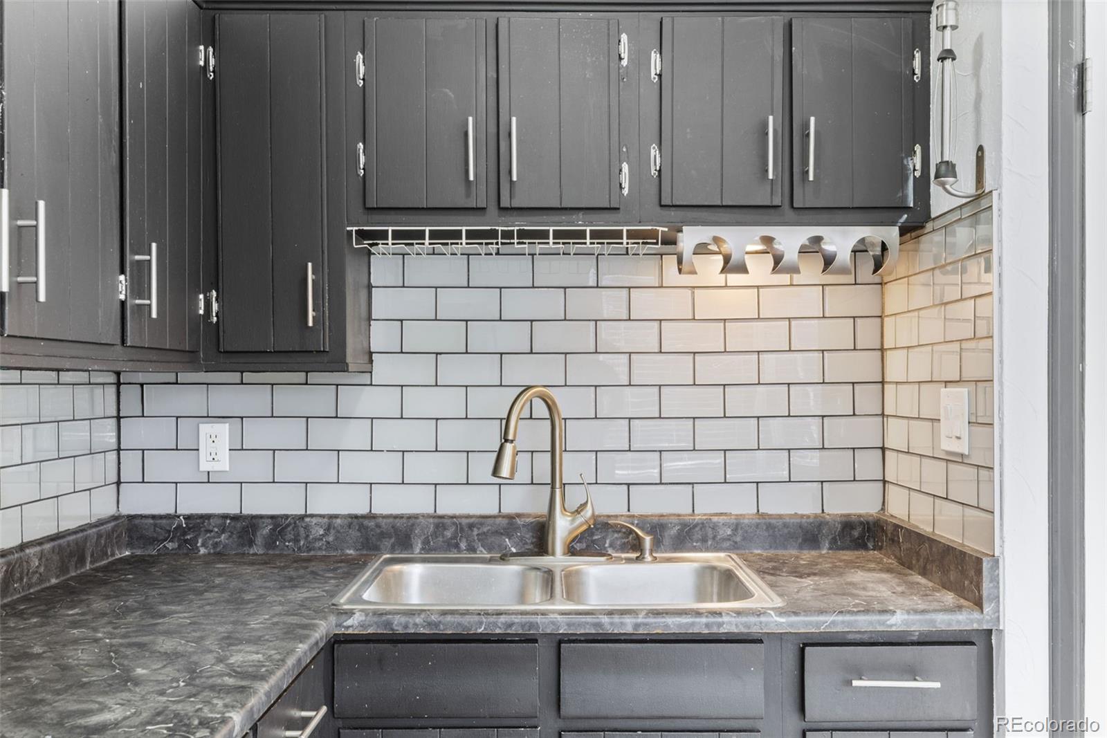 1630 Chester Street Aurora, CO 80010 - Photo 17 of 31 a kitchen with a sink and a cabinets