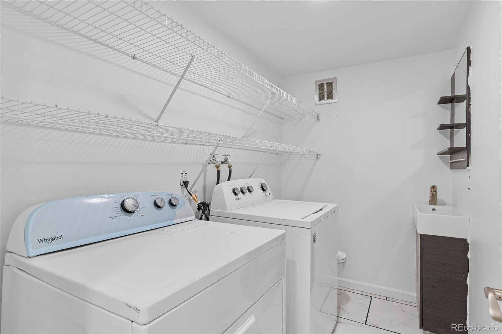 1630 Chester Street Aurora, CO 80010 - Photo 18 of 31 a utility room with dryer and washer