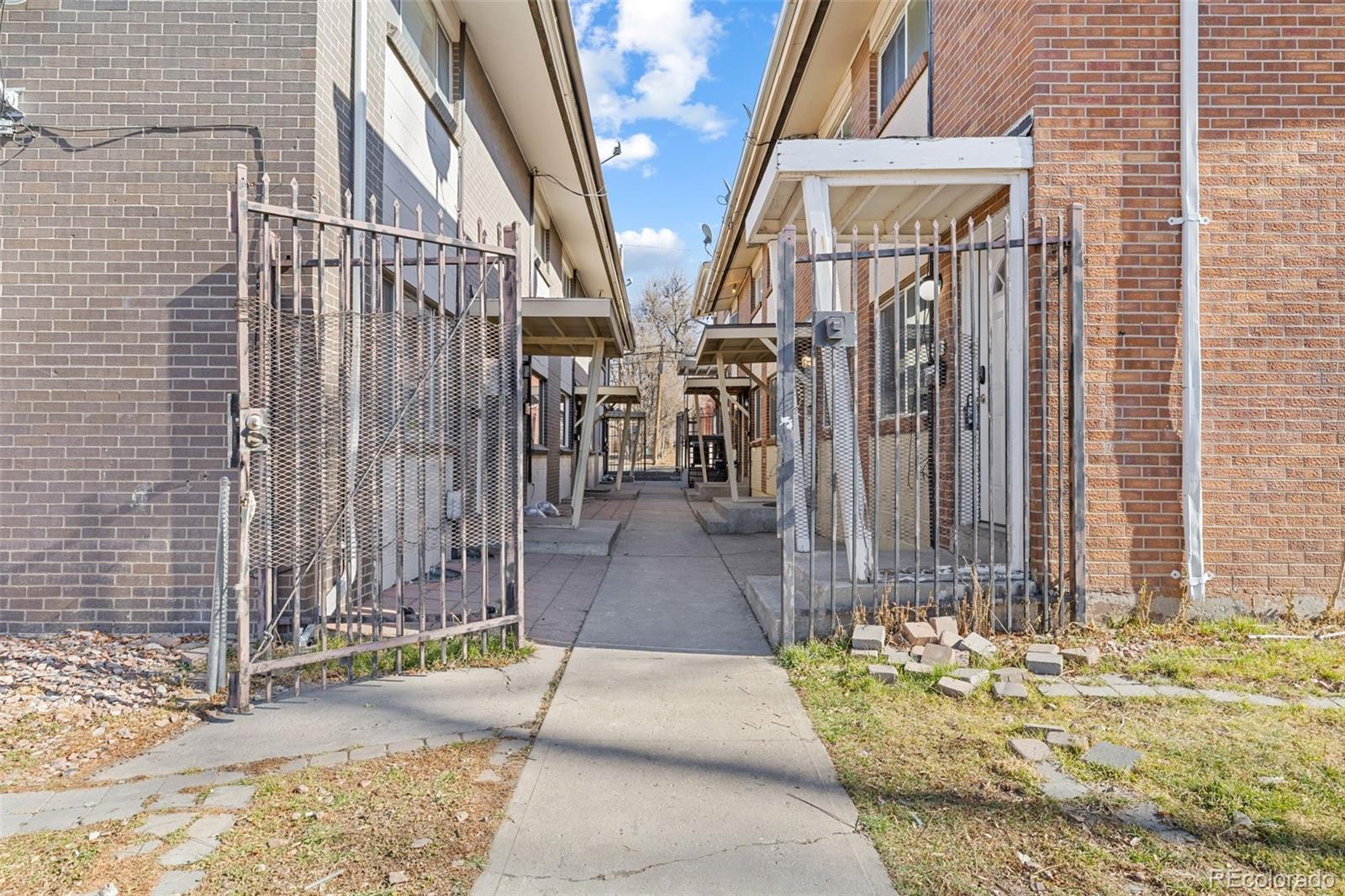 1630 Chester Street Aurora, CO 80010 - Photo 2 of 31 a view of a pathway along a building