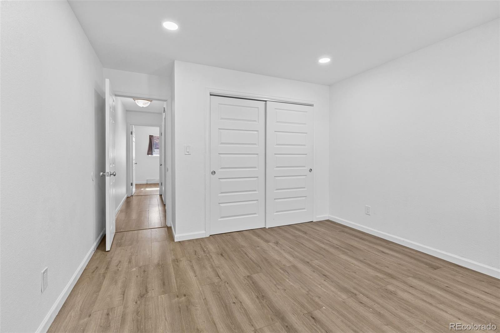 1630 Chester Street Aurora, CO 80010 - Photo 22 of 31 wooden floor in an empty room with a window