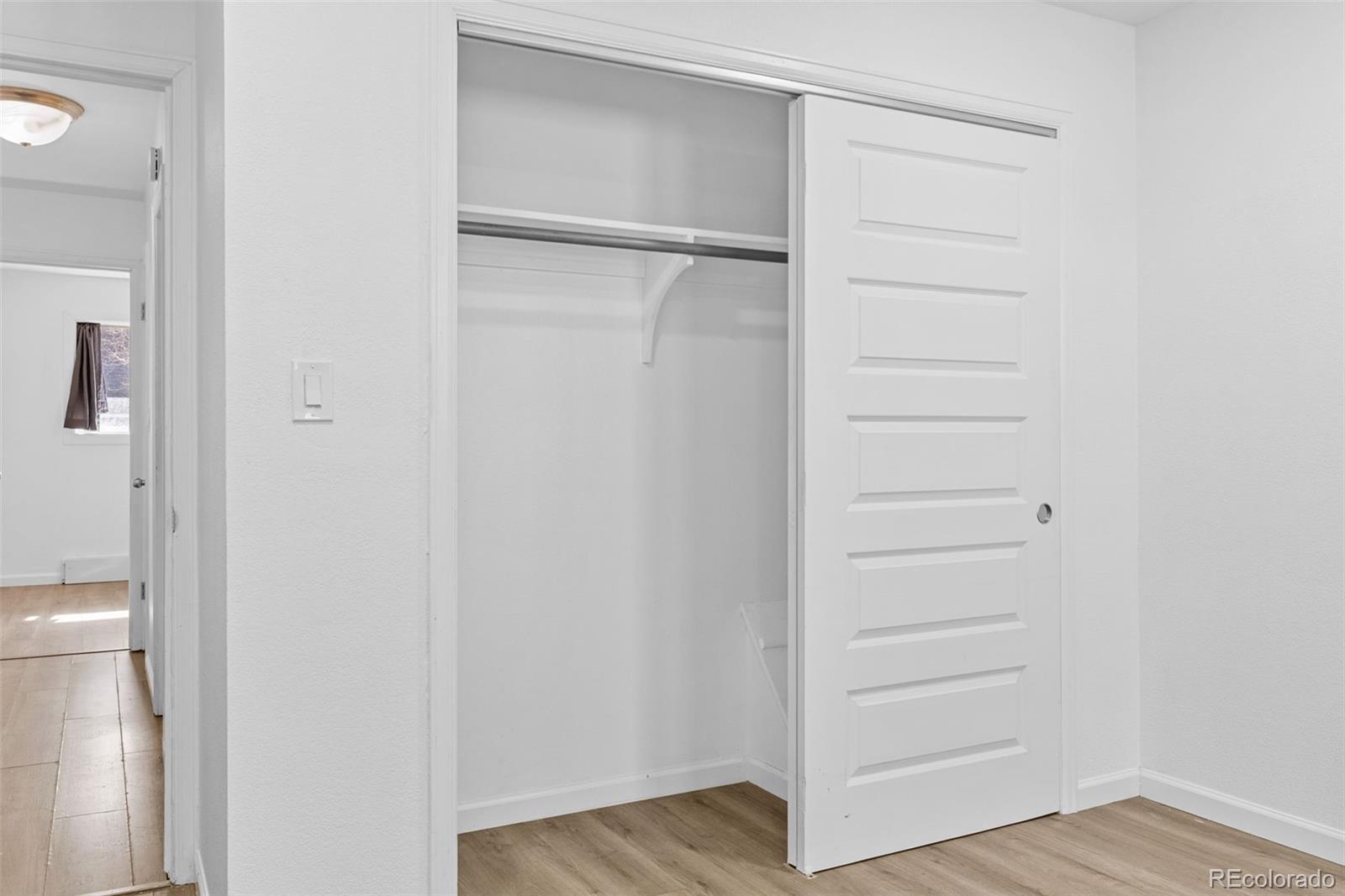 1630 Chester Street Aurora, CO 80010 - Photo 25 of 31 a view of walk in closet with empty racks