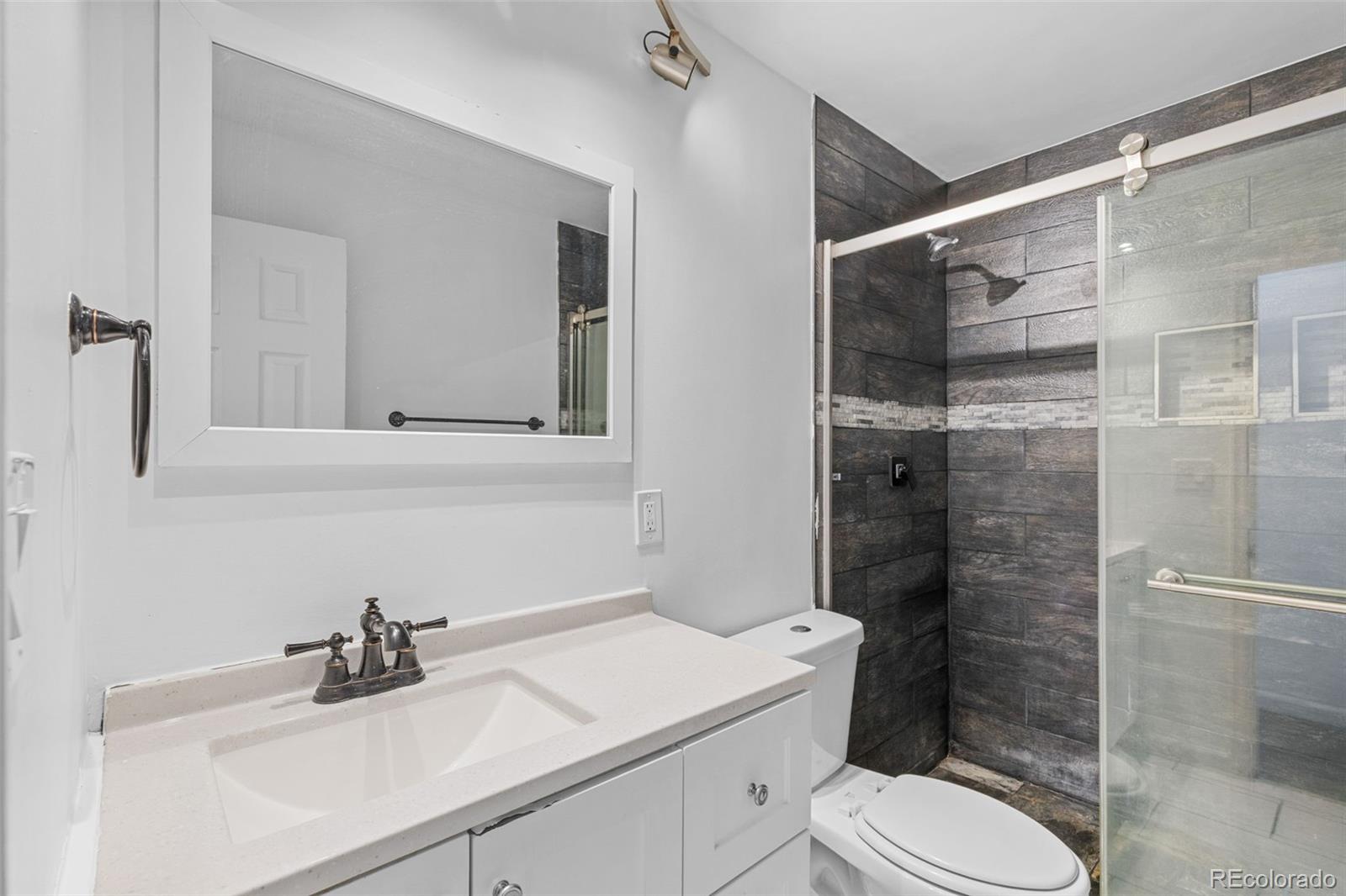 1630 Chester Street Aurora, CO 80010 - Photo 26 of 31 a bathroom with a sink toilet and shower