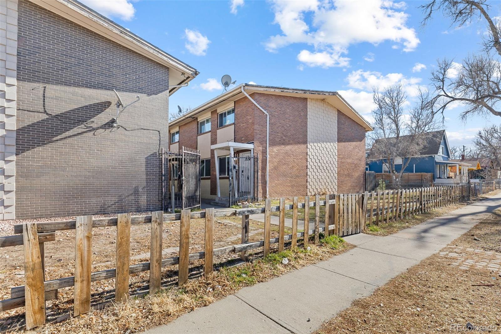 1630 Chester Street Aurora, CO 80010 - Photo 3 of 31 a front view of a house with a yard