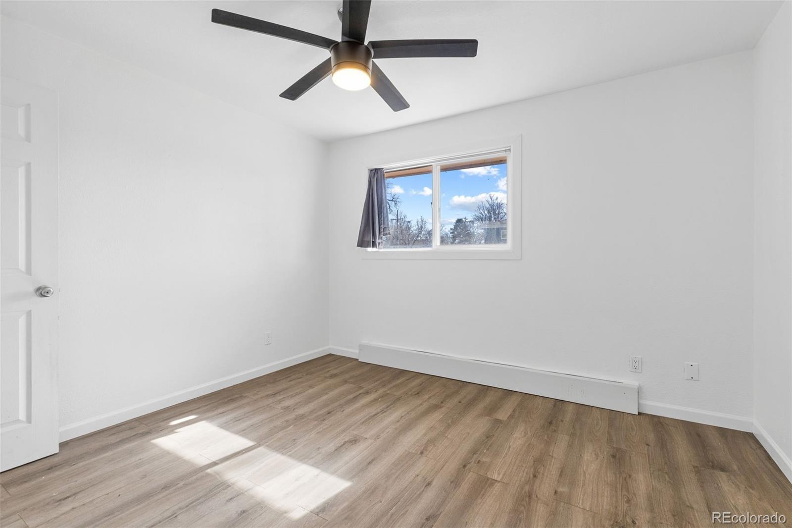 1630 Chester Street Aurora, CO 80010 - Photo 31 of 31 an empty room with a window and a ceiling fan
