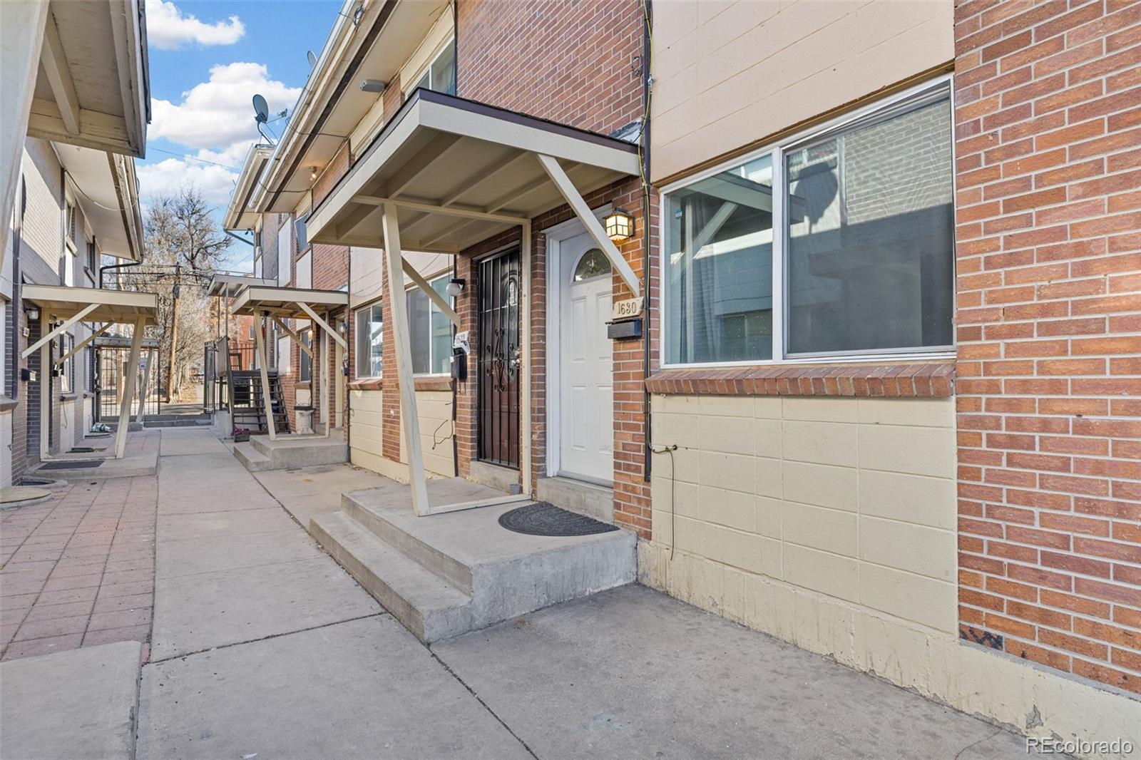 1630 Chester Street Aurora, CO 80010 - Photo 4 of 31 a view of a brick house with a large windows