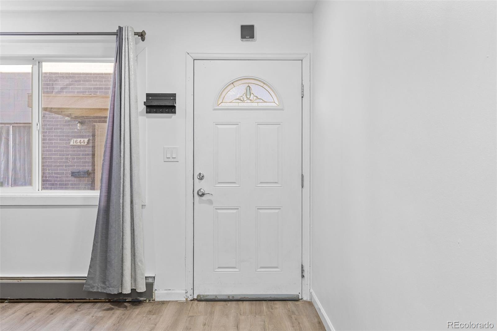 1630 Chester Street Aurora, CO 80010 - Photo 6 of 31 a view of an entryway with wooden floor