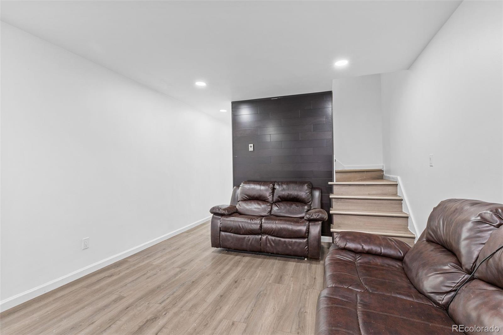 1630 Chester Street Aurora, CO 80010 - Photo 8 of 31 a living room with furniture and stairs