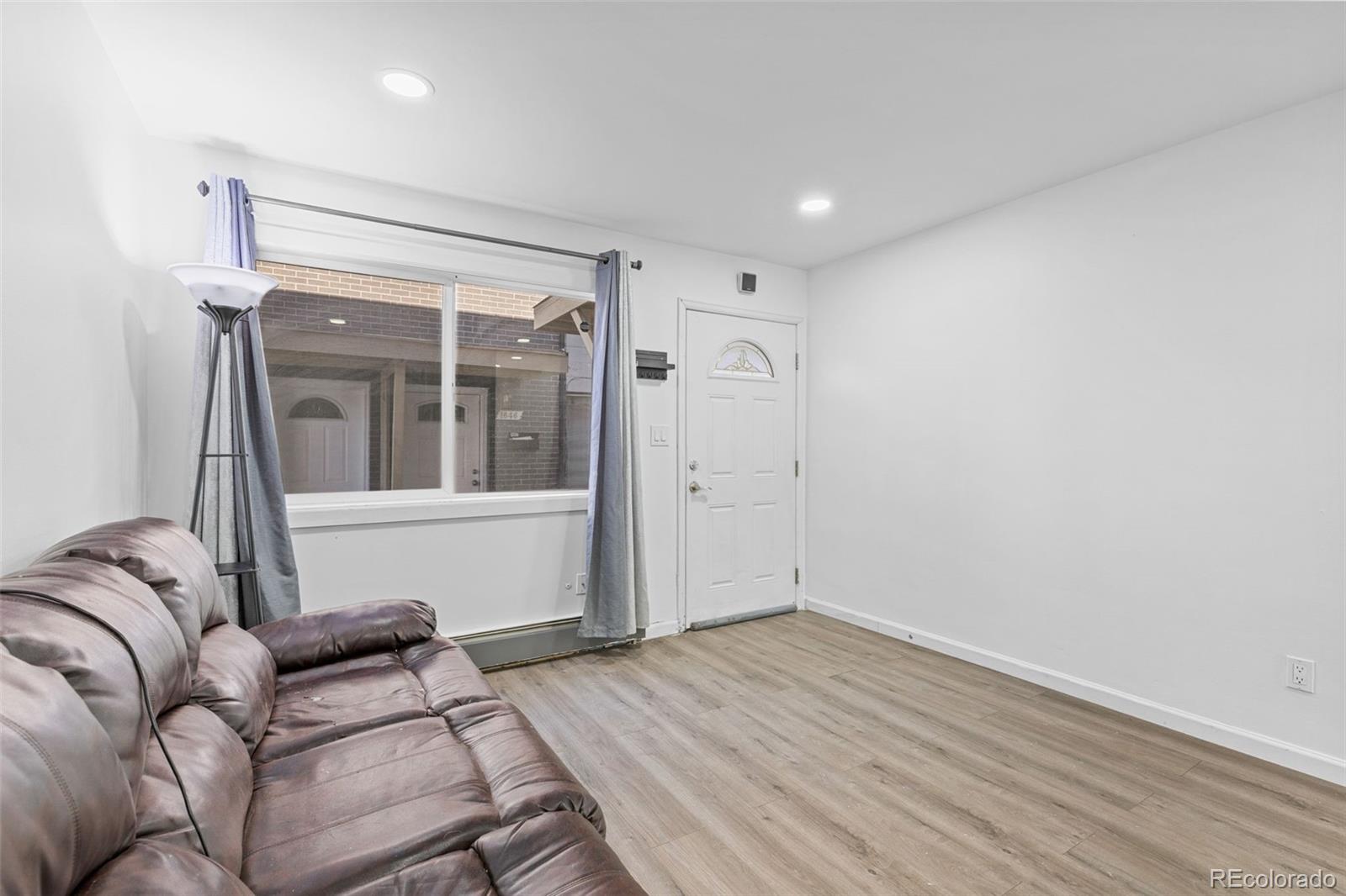 1630 Chester Street Aurora, CO 80010 - Photo 9 of 31 a living room with furniture and a window