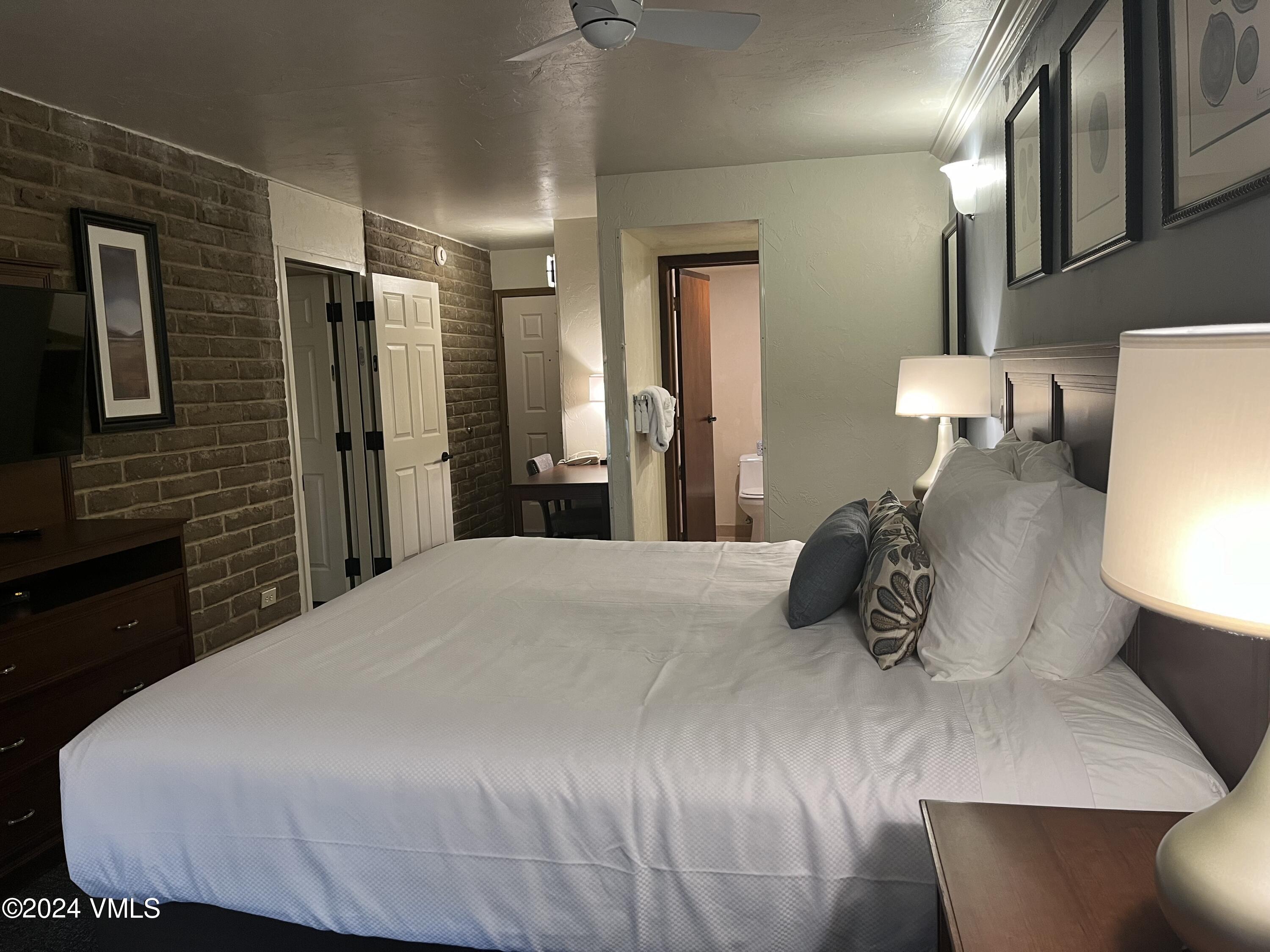 1020 Vail View Drive, Unit 110837 Vail, CO 81657 - Photo 6 of 21 a bedroom with a bed and a lamp